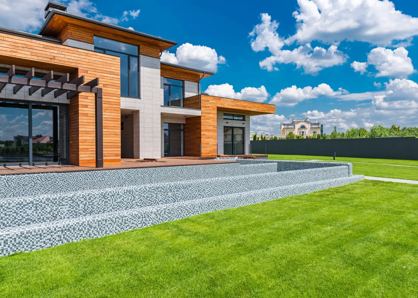 Contemporary home with panoramic glazing opening to a green lawn