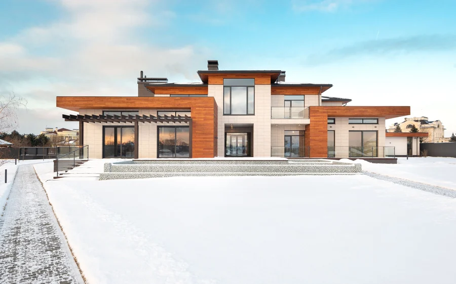 Front elevation at dusk with the driveway lit