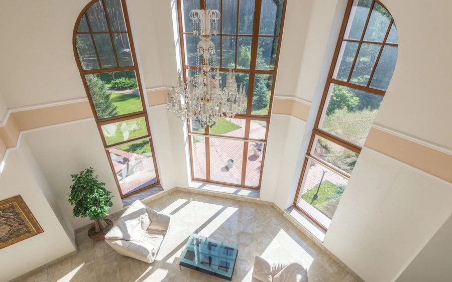 Double-height living area with a grand chandelier