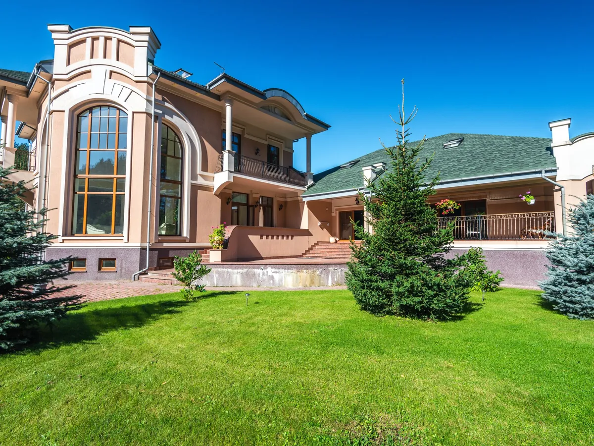 Modern luxury villa with floor-to-ceiling windows and a lawn