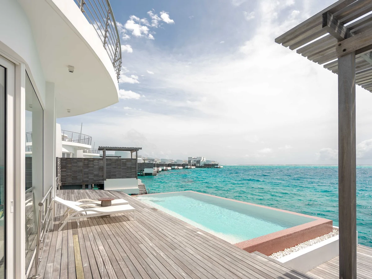 Oceanfront villa with an infinity pool at dusk
