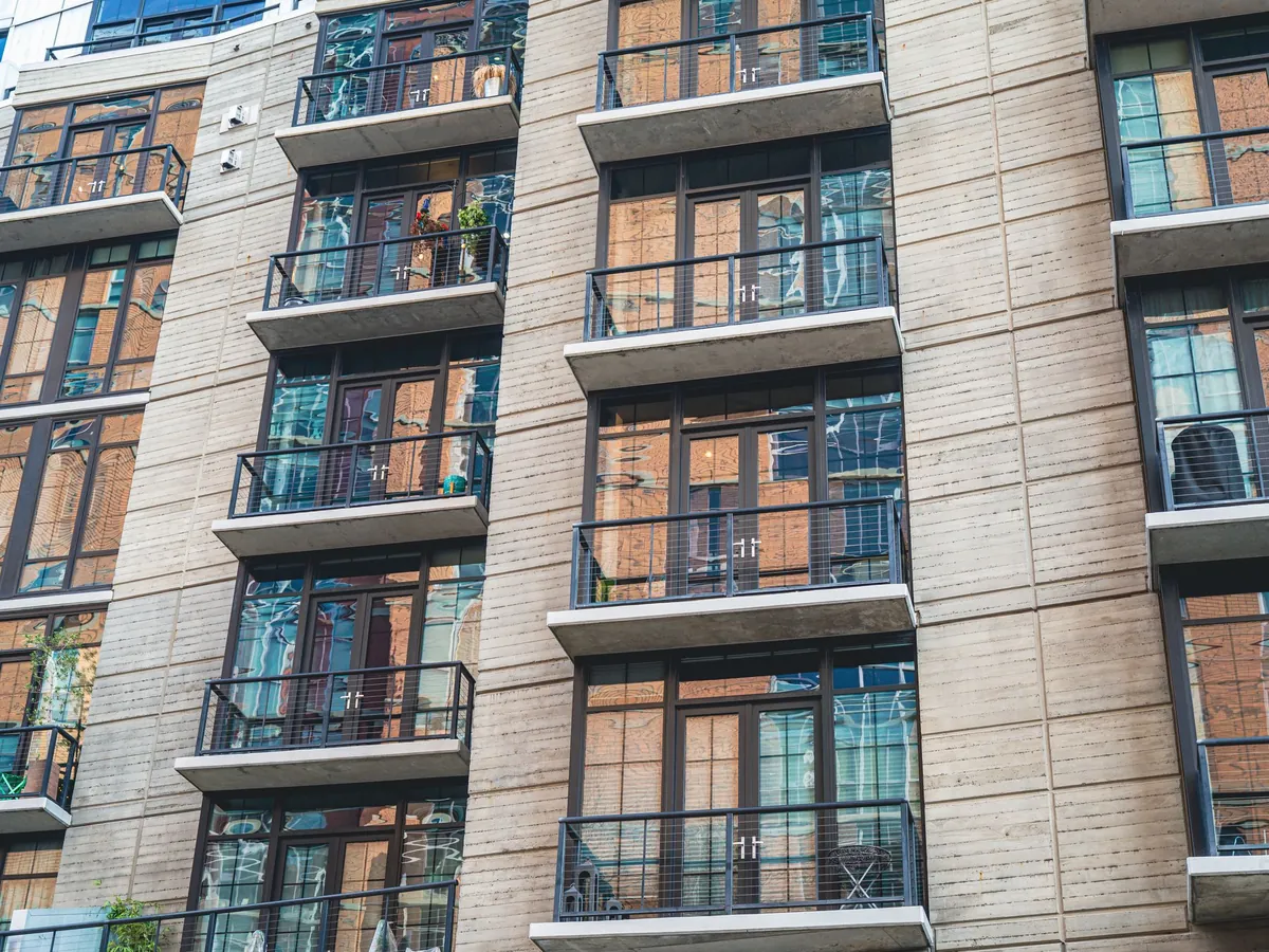 Apartment block with a concrete facade and glass balconies