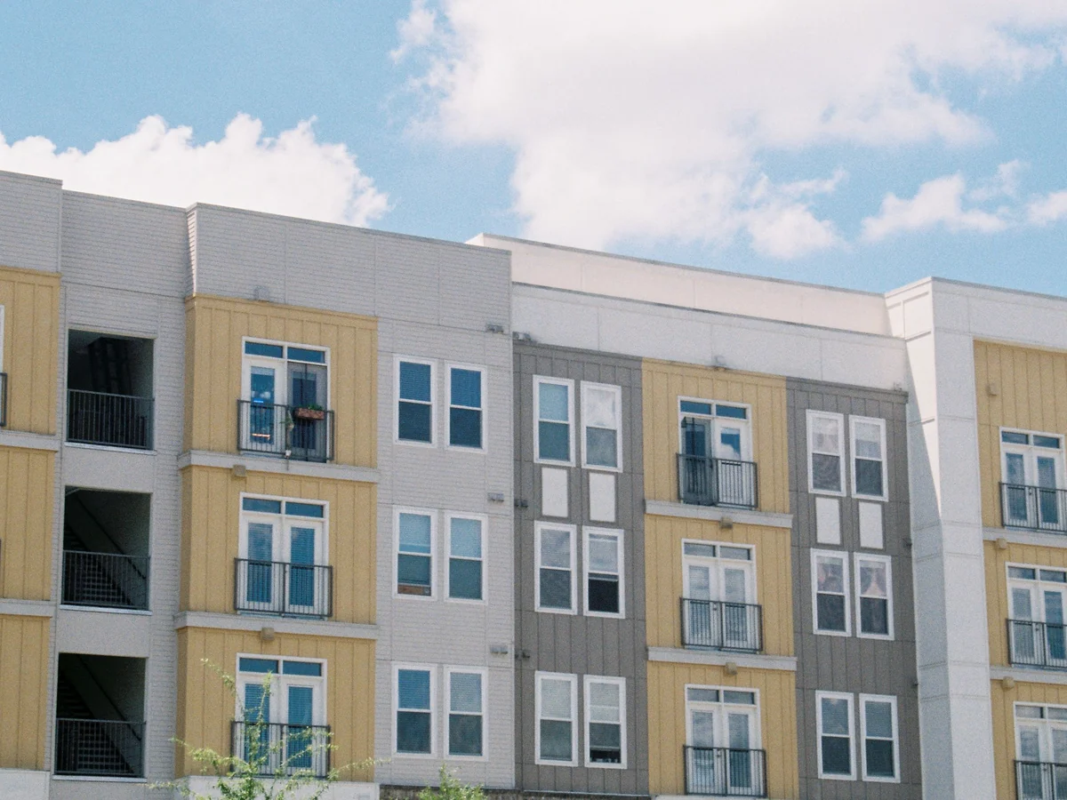 Low-rise apartment building with pale panel cladding