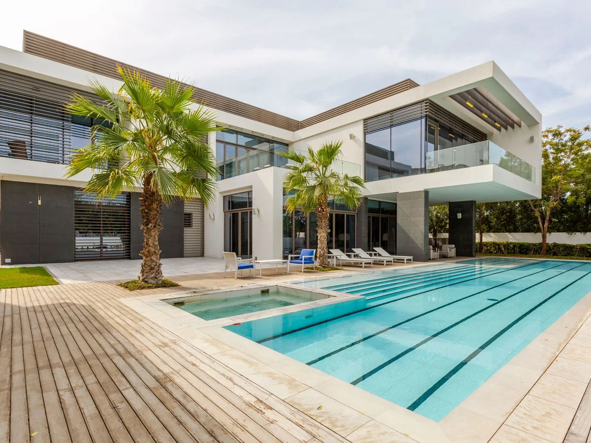 Modern villa with a swimming pool framed by palm trees